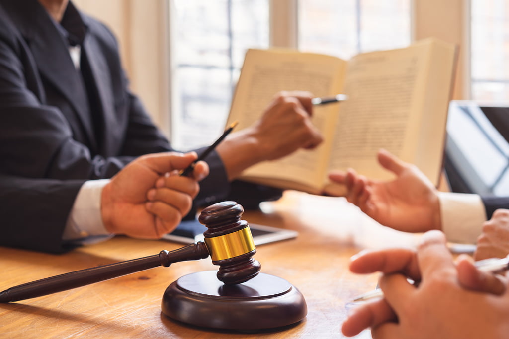 Lawyers and judges in a courtroom, discussing legal proceedings and making significant decisions.