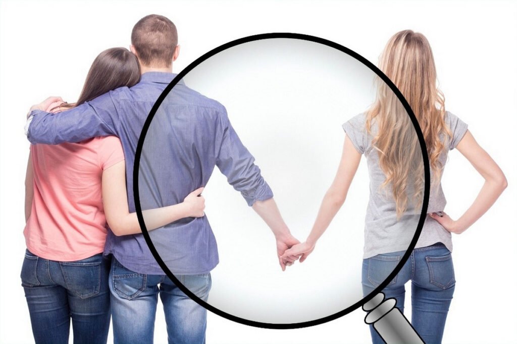 A couple's hands clasped together under a magnifying glass.