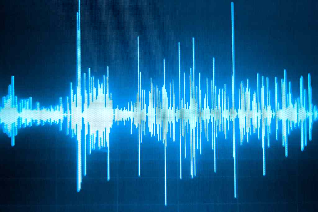 Sound wave on a blue background - a visual representation of audio frequencies in a monochromatic manner.