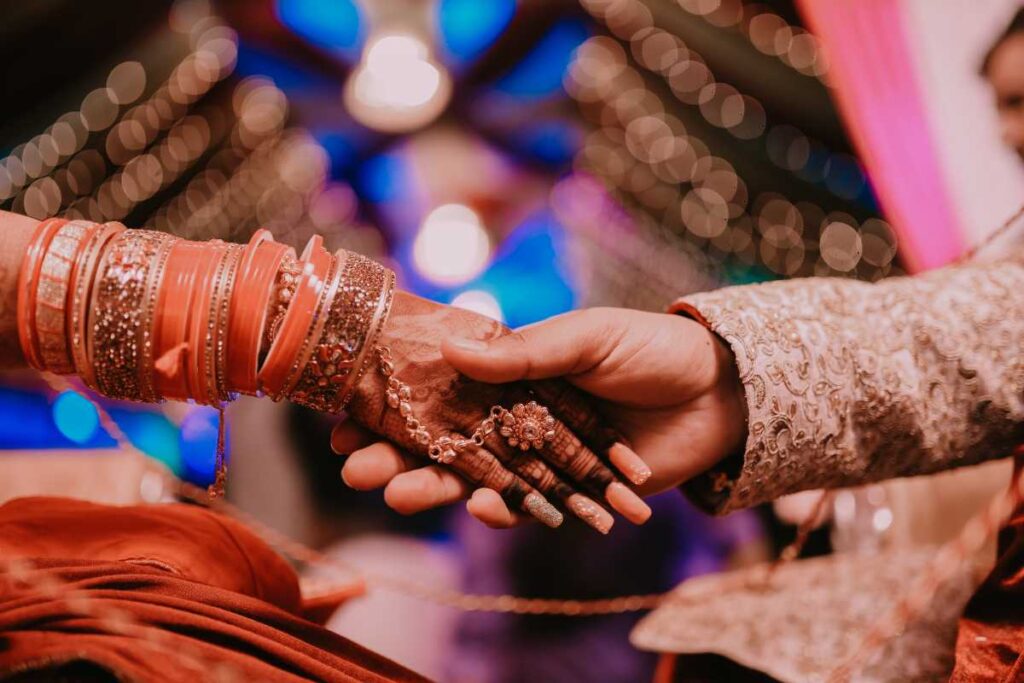 An Indian wedding ceremony with vibrant colors, traditional attire, and intricate decorations.