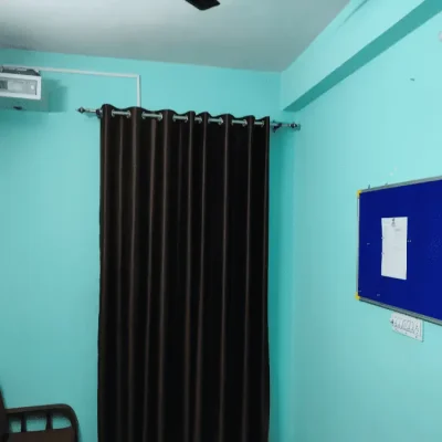 Office of Action Detective in Jaipur. Brown curtain and turquoise colored wall visible.